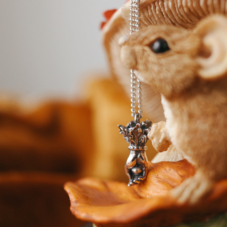 Tiny Acorn in Hand Necklace from Shop Dixi